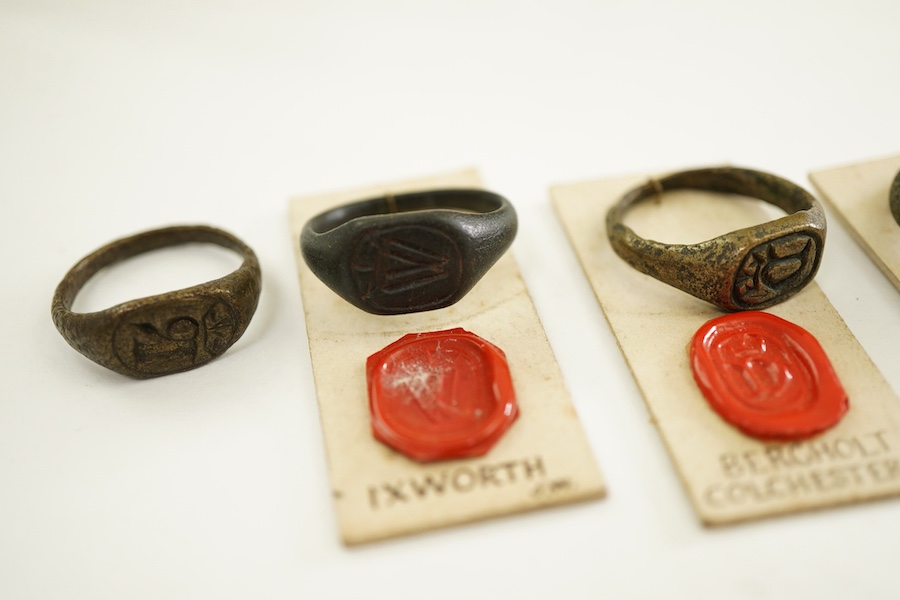 A collection of six bronze signet rings, England, circa 16th century, each engraved with an initial, largest size V, Provenance: formerly in the collection of Dame Joan Evans (1893-1977)
